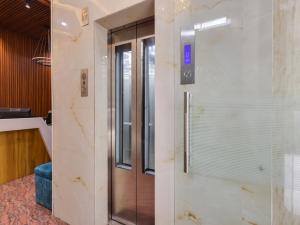 a elevator in a building with a glass door at Townhouse Royal Inn in Guwahati