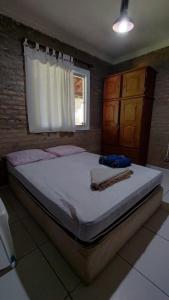 a large bed in a bedroom with a window at Sitio Mãe Rainha in Petrolina