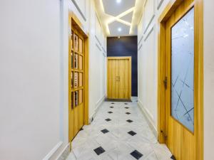 a hallway with wooden doors and a tiled floor at Townhouse Royal Inn in Guwahati