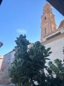a plant in front of a building with a clock tower at Henko-Alloza in Alloza