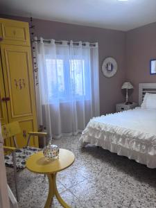 a bedroom with a bed and a table and a yellow cabinet at Henko-Alloza in Alloza