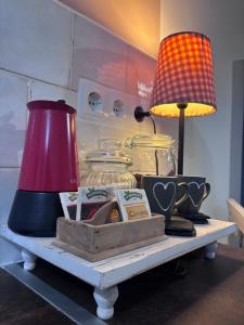 a table with a lamp and other items on it at Henko-Alloza in Alloza +1 photo