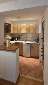 a kitchen with wooden cabinets and white appliances at Ferienwohnung am Töpferberg in Löbau +4 photos