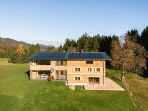 a house with a metal roof on a green field at Freiheit in Bolsterlang