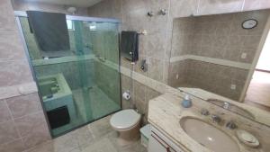 a bathroom with a sink and a shower and a toilet at Varanda do forte in Cabo Frio +20 photos
