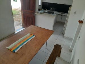 a kitchen with a wooden table with a colorful napkin on it at Fênix in Porto Velho