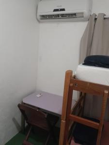 a room with a bed and a desk and a air conditioner at Fênix in Porto Velho +1 photo
