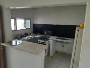 a kitchen with a stove and a counter top at Fênix in Porto Velho