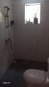 a bathroom with a toilet and a window at Arijaana Guest Studio in Gunjur