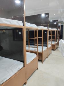 a row of bunk beds in a dorm room at Viresh Cottage in Solapur +8 photos