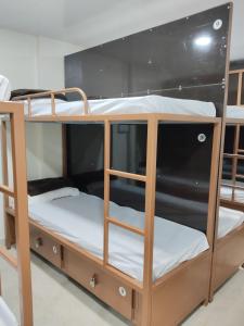 a couple of bunk beds in a room at Viresh Cottage in Solapur