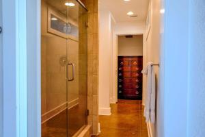 a bathroom with a shower with a glass door at Salty Bay Hideaway in Gulf Breeze +12 photos