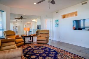 a living room with a couch and chairs and a table at Salty Bay Hideaway in Gulf Breeze