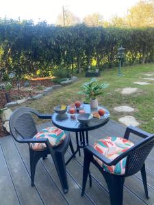 a table with two chairs and a table with food on it at chez Sandrine in La Gacilly