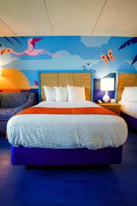 a bedroom with a large bed with butterflies on the wall at Castaway Bay by Cedar Point Resorts in Sandusky