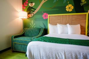 a hotel room with a bed and a chair at Castaway Bay by Cedar Point Resorts in Sandusky +66 photos