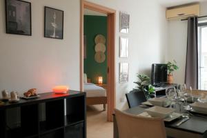 a living room with a dining table and a bedroom at Porto by Shmoo! in Is-Swieqi
