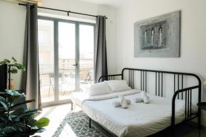 a bedroom with a bed with two teddy bears on it at Porto by Shmoo! in Is-Swieqi +28 photos