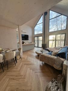 a large living room with a bed and a table at Cëchô Woda in Parchowo