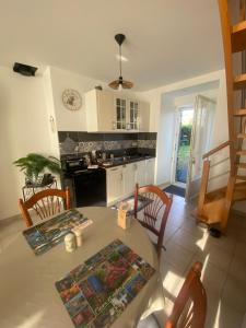 a kitchen with a table and chairs and a kitchen with a stove at chez Sandrine in La Gacilly