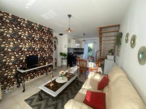 a living room with a couch and a tv at chez Sandrine in La Gacilly