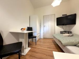 a living room with a couch and a desk with a tv at Chińczyk in Inowrocław