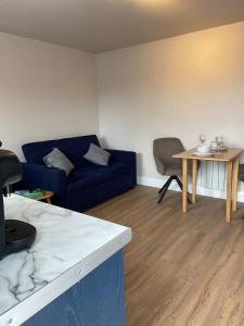 a living room with a blue couch and a table at Meadow View in Birr