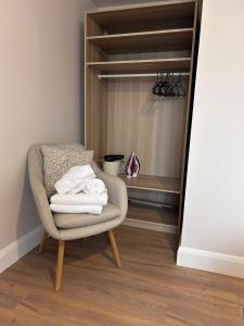 a chair with a pile of towels in a closet at Meadow View in Birr +6 photos