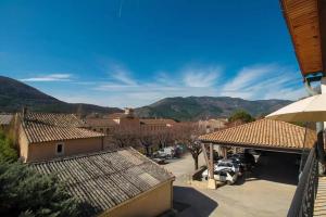 a view of a town with mountains in the background at Studio Walla Confort Centre in Montbrun-les-Bains