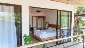 a bedroom with a bed on a balcony at Aduana House in Santa Teresa Beach