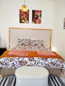 a bed in a bedroom with two pictures on the wall at Cosy Loft by l'Arche de Jo in Santana