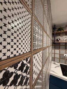 a wall covered in black and white tiles at Gibertino by Cinque Terre in Isabela +9 photos