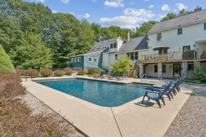 a swimming pool in front of a house at Wildflower Retreat in Kennebunk