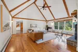 a living room with a ceiling fan and a couch at Wildflower Retreat in Kennebunk