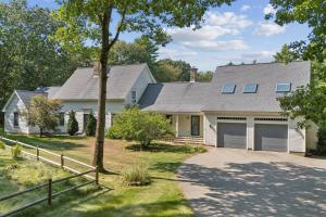 a white house with a fence and a driveway at Wildflower Retreat in Kennebunk