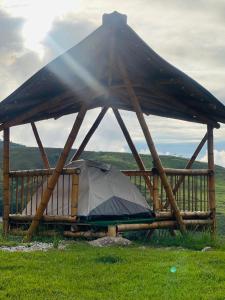 a tent in a wooden structure in a field at Conexión naturaleza in San Luis