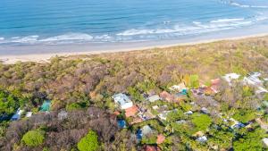 an aerial view of a beach with houses and the ocean at Serena Nosara Beach Retreat in Nosara