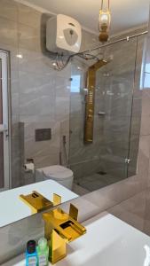 a bathroom with a glass shower and a sink at Hotel Bonavista in Nuwara Eliya +55 photos