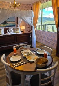 a table with plates of food on it in a bedroom at Hotel Bonavista in Nuwara Eliya