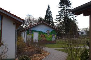 a building with a mural on the side of it at Weserberglandalm Haus 3 in Ottenstein