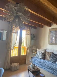 a living room with a couch and a large umbrella at Le cosy d Asmae in Ustou