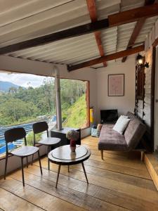 a living room with a couch and a table at Cabañas Valle del Cocora La Truchera in Salento