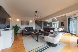 a living room with a couch and a table at Villa Poljine GREEN in Sarajevo