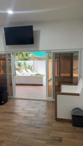 a living room with a flat screen tv on the wall at Monterrico VIP in La Candelaria
