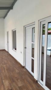 an empty room with doors and a wooden floor at Monterrico VIP in La Candelaria