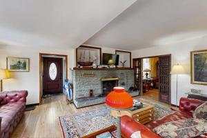 a living room with a couch and a fireplace at Hidden Haven in Bath
