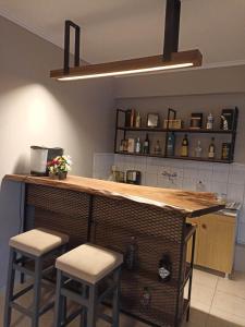 a kitchen with a counter with two stools at a bar at Europa Hotel Korinos in Korinos