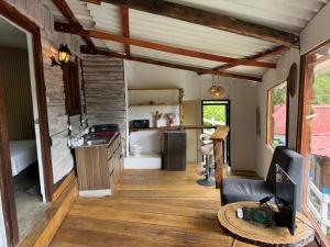 a kitchen and living room of a tiny house at Cabañas Valle del Cocora La Truchera in Salento