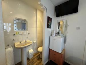 a bathroom with a sink and a toilet at The Scala Hotel in Blackpool +61 photos