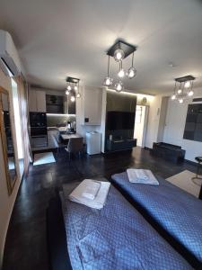 a living room with a bed and a dining room at MonDa apartman in Salgótarján